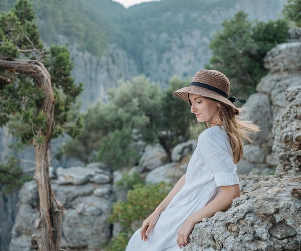 Person meditating peacefully in a serene environment with soft lighting.